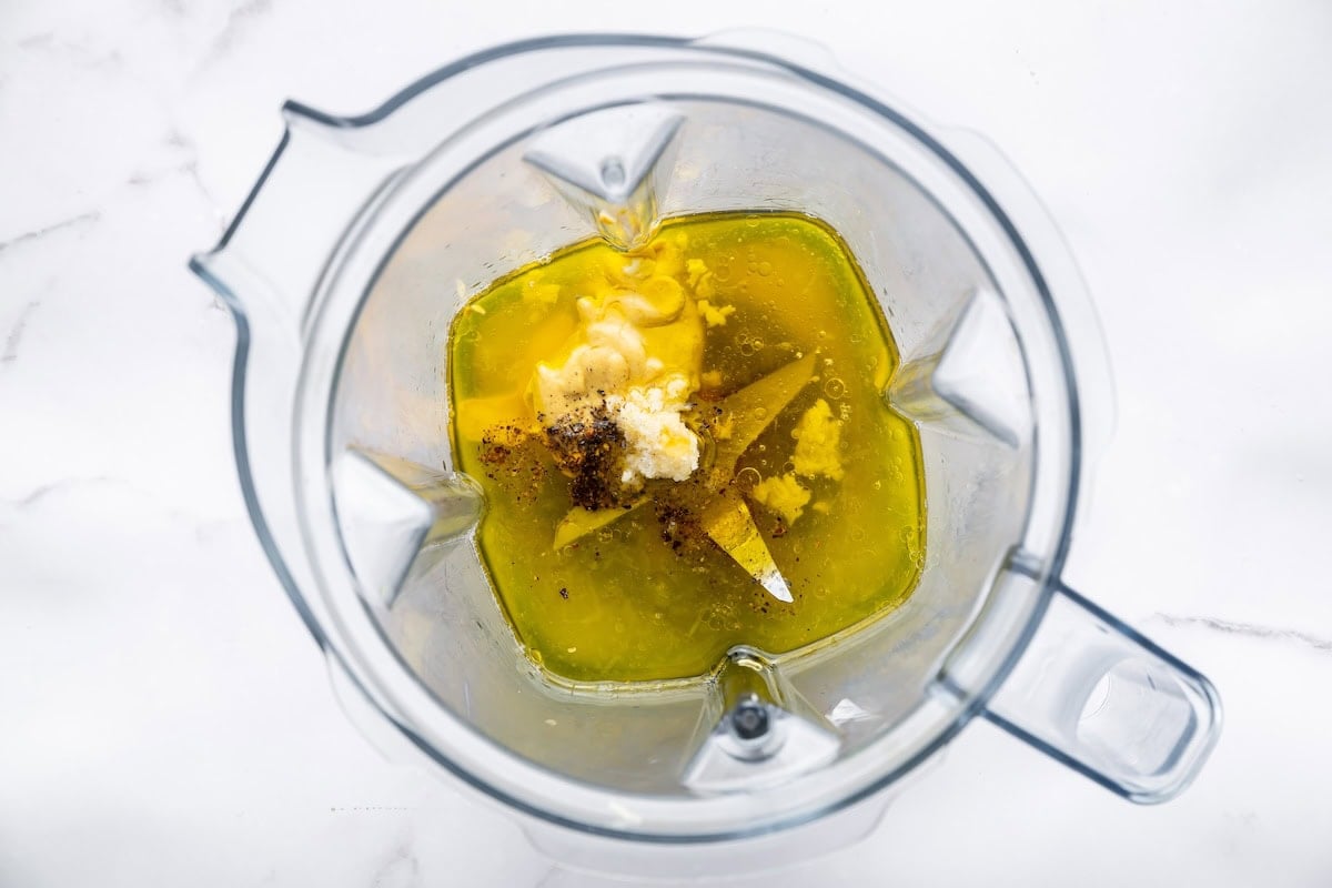 Honey mustard dressing ingredients in a blender before being blended.