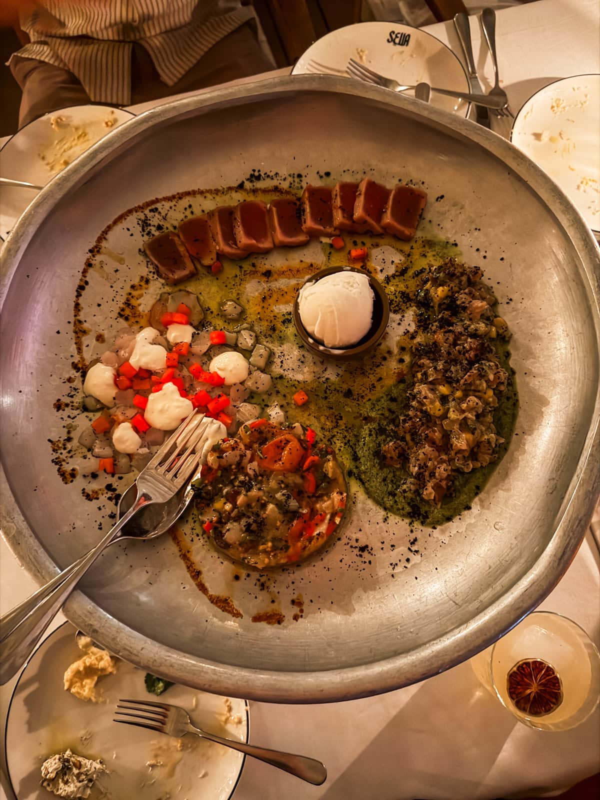 Large shared platter with eggplant, fish, and mezze at Sella restaurant in St. Barths