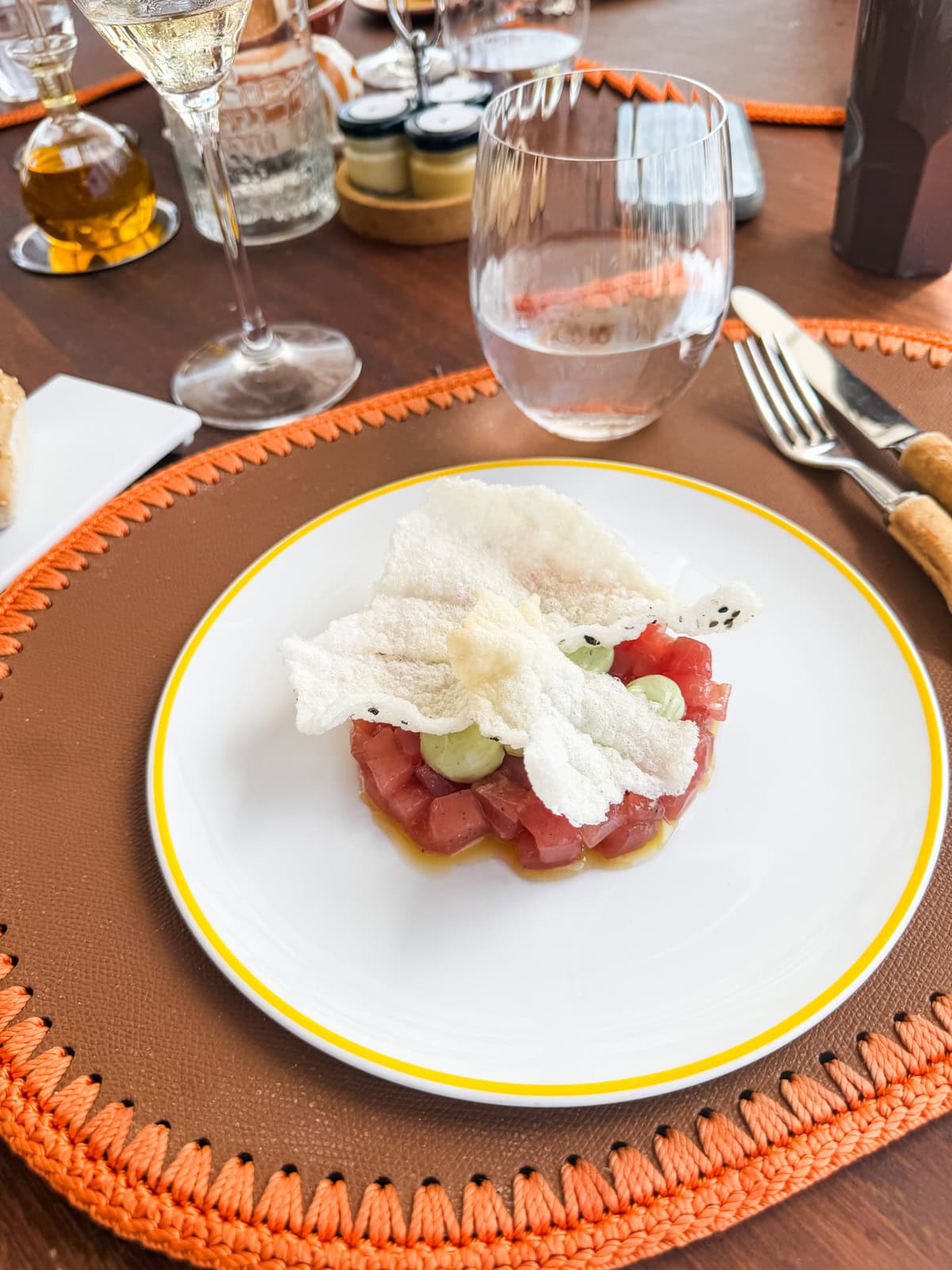 Tuna tartare on crispy rice on a yellow rimmed plate at Cheval Blanc in St. Barths