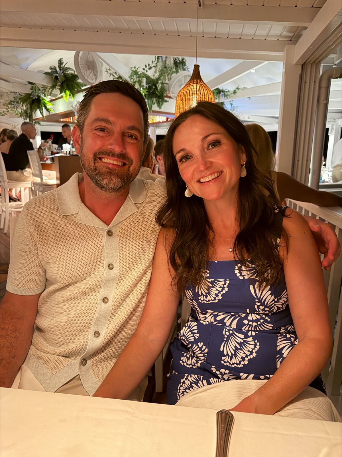 Brittany and Isaac smiling at the Sand Bar restaurant at Eden Rock in St. Barths