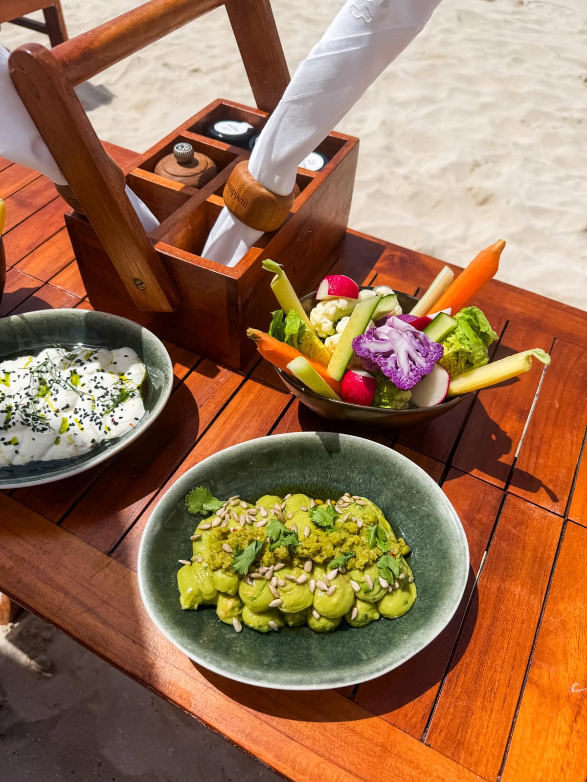 Green pea guacamole, labneh dip, and veggie crudites at the Sand Bar beach restaurant at Eden Rock