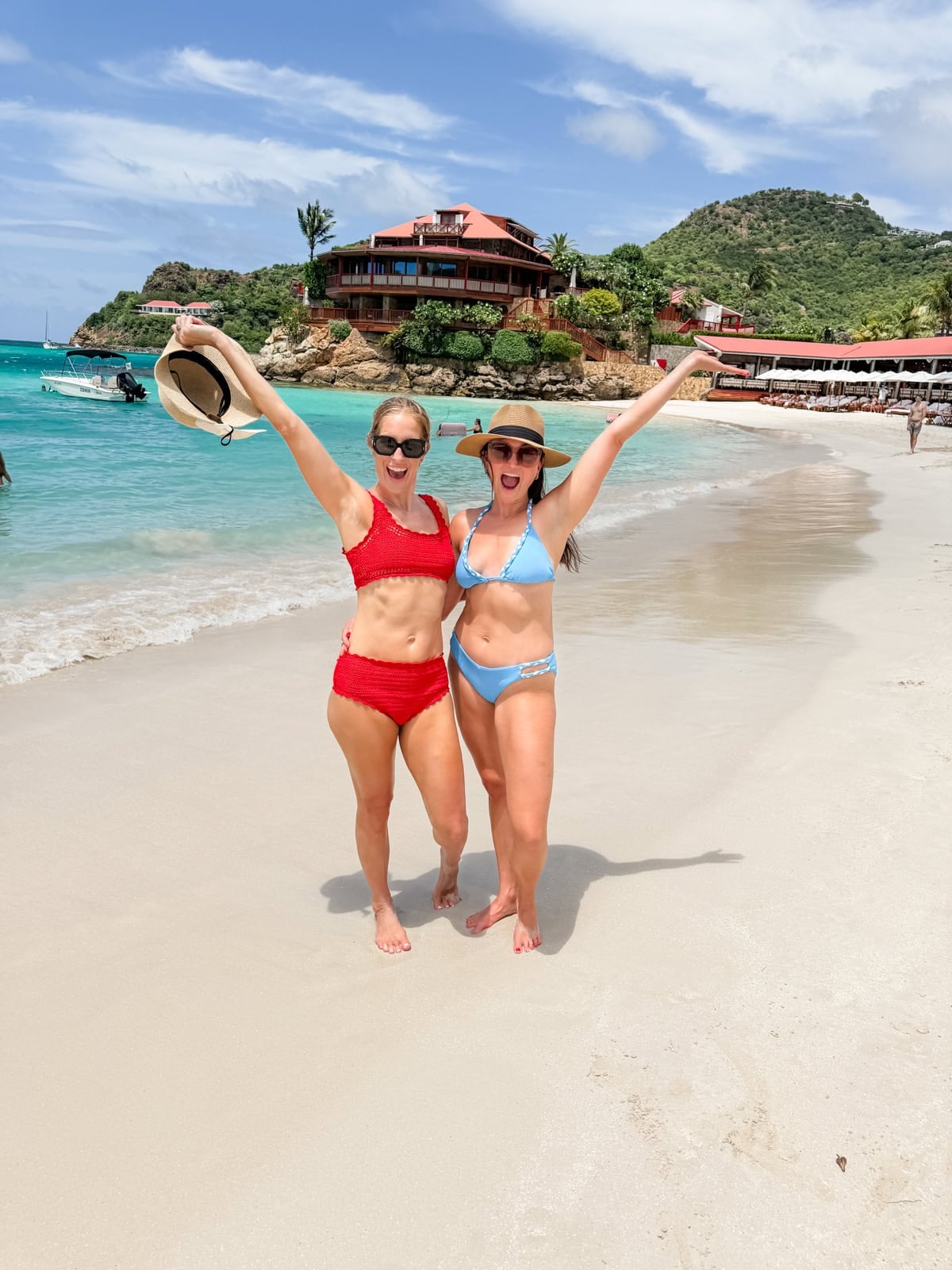 Brittany and friend celebrating on the beach at St. Jean Bay with Eden Rock in the background