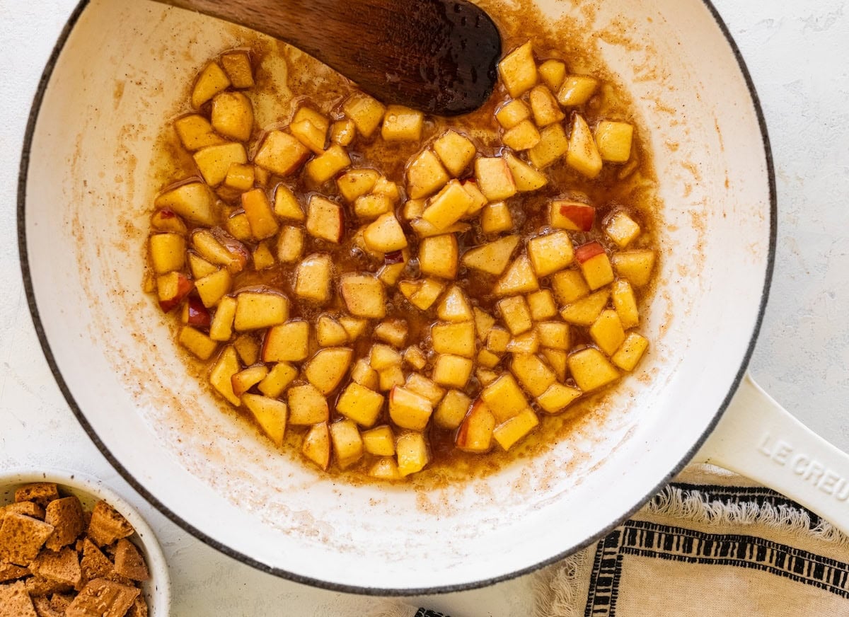 Cinnamon apples cooking on a skillet for the apple pie ice cream.