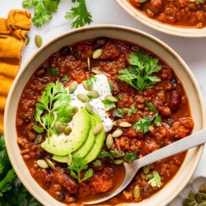 Pumpkin chili topped with avocado, Greek yogurt, pepitas and parsley with cornbread on the side.