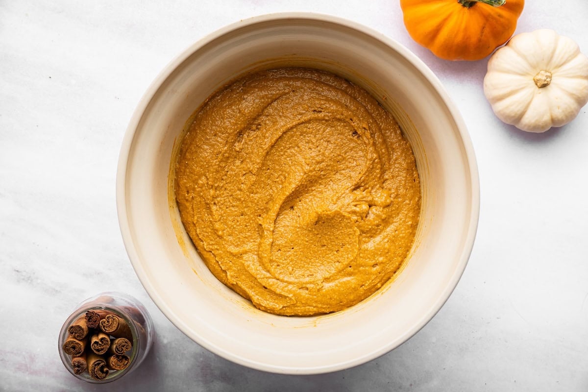 Thick pumpkin bread batter in a mixing bowl after combining the wet and dry ingredients.