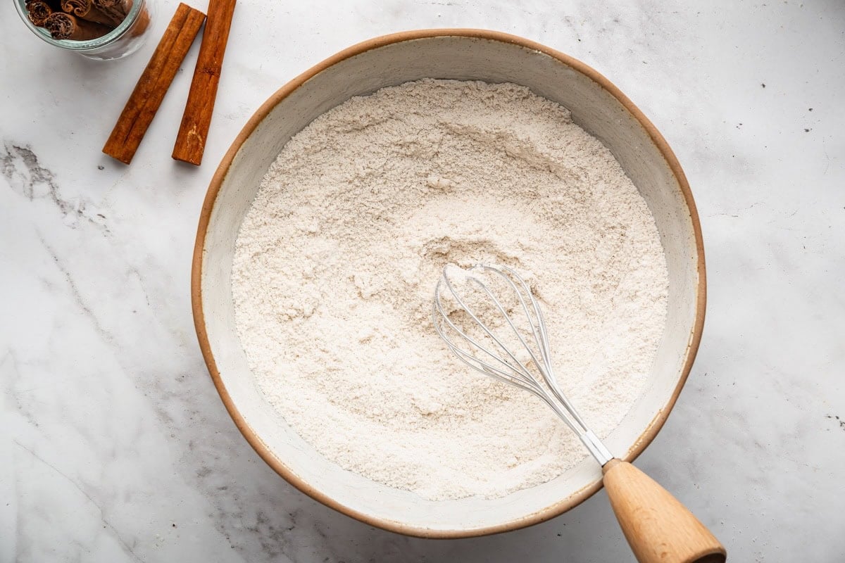 Dry ingredients being whisked together in a mixing bowl.