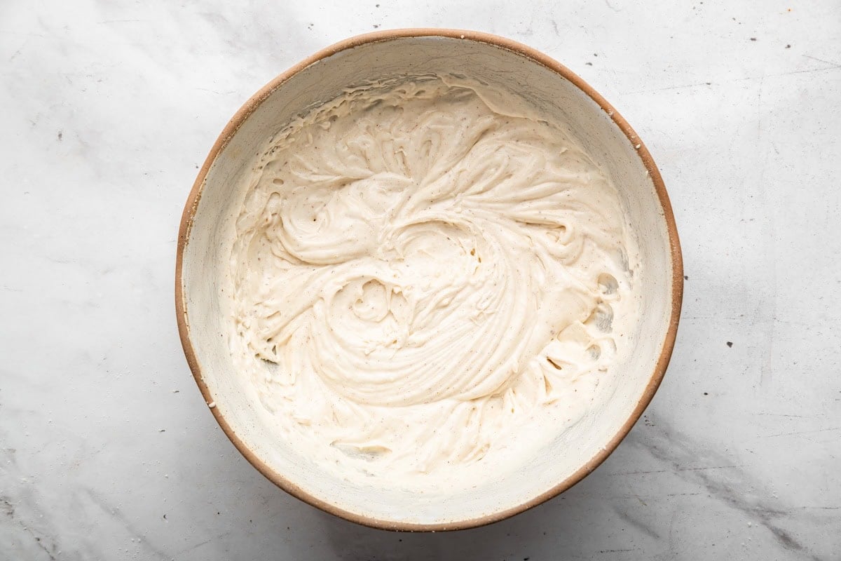 Cinnamon cream cheese frosting in a mixing bowl.
