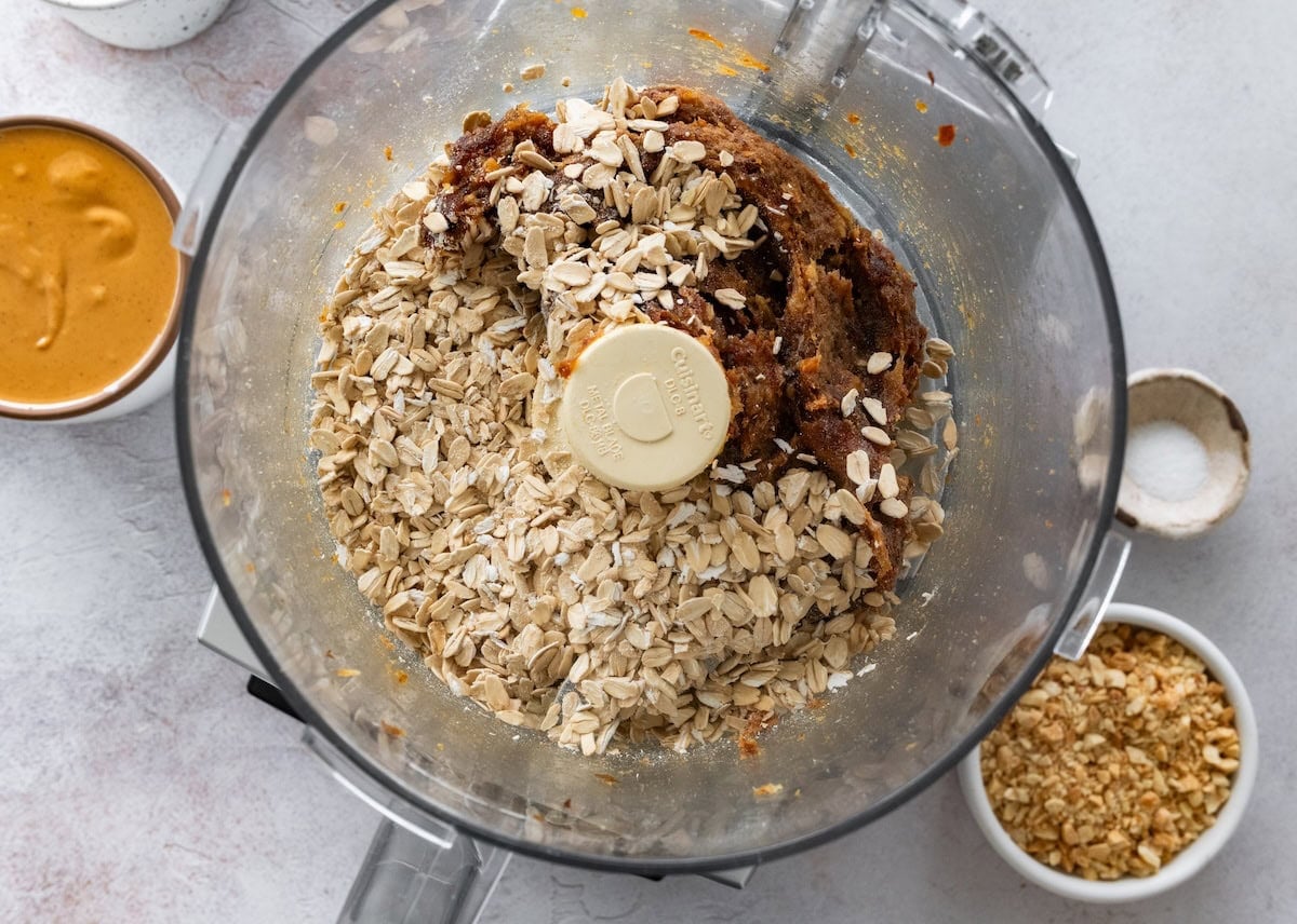 Chopped dates and rolled oats in a food processor.